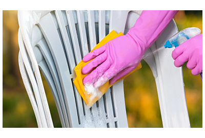 muž čistí zelenou plastovou židli